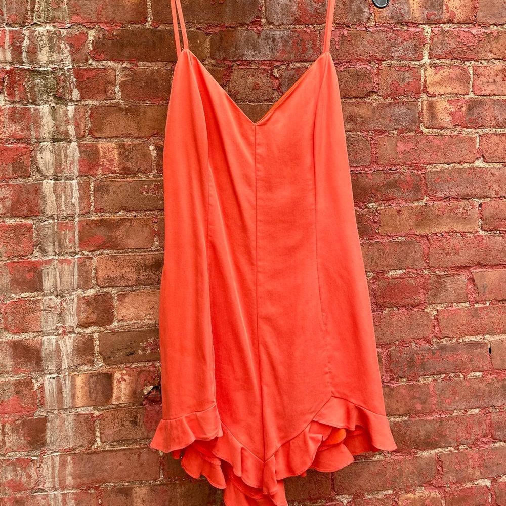 NBD orange romper with ruffle. Size Small.
